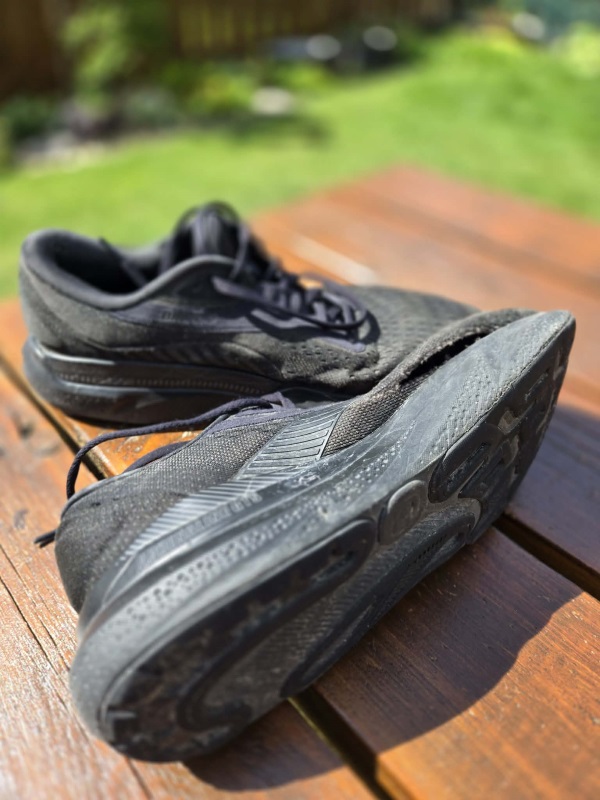 Shoe with worn out torn upper Shoe with worn out torn upper